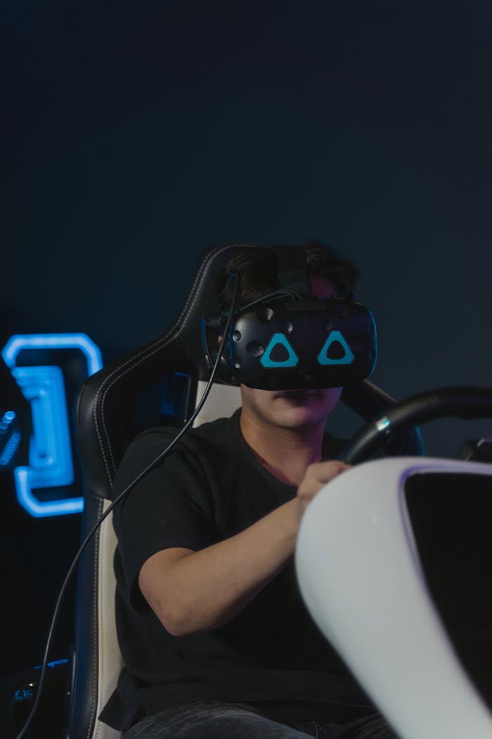 A Man Wearing VR Glasses while Controlling a Steering Wheel